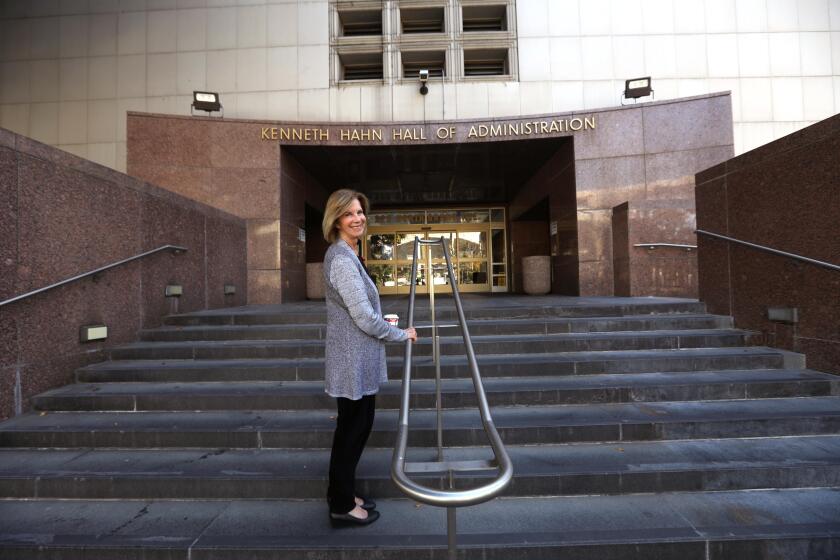 LOS ANGELES, CA - DECEMBER 20, 2024 - - Los Angeles Supervisor Janice Hahn stands outside the Kenneth Hahn Hall of Administration building along Grand Avenue in Los Angeles on December 20, 2024. Supervisor Hahn and preservationists are pushing back against a plan to move workers into the newly purchased skyscraper on Bunker Hill and raze the Kenneth Hahn Hall of Administration, which was renamed after Hahn's father and is a centerpiece of the government-oriented Civic Center neighborhood. (Genaro Molina/Los Angeles Times)