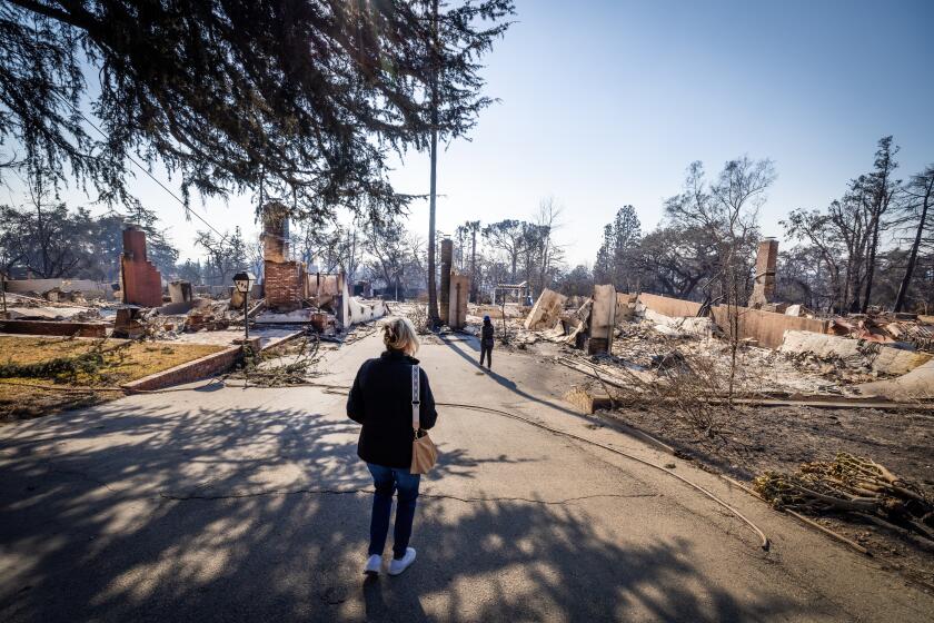 Altadena, CA - January 11: Los Angeles County Supervisor Kathryn Barger surveys the Eaton fire damage while taking a walking tour past thousands of burned out homes in her district in Altadena Saturday, Jan. 11, 2025. (Allen J. Schaben / Los Angeles Times)