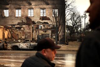 ALTADENA, CA, JANUARY 9, 2025: People stop to take in the scene of burned down businesses along Lake Avenue in Altadena on Thursday, January 9, 2025. (Christina House / Los Angeles Times)