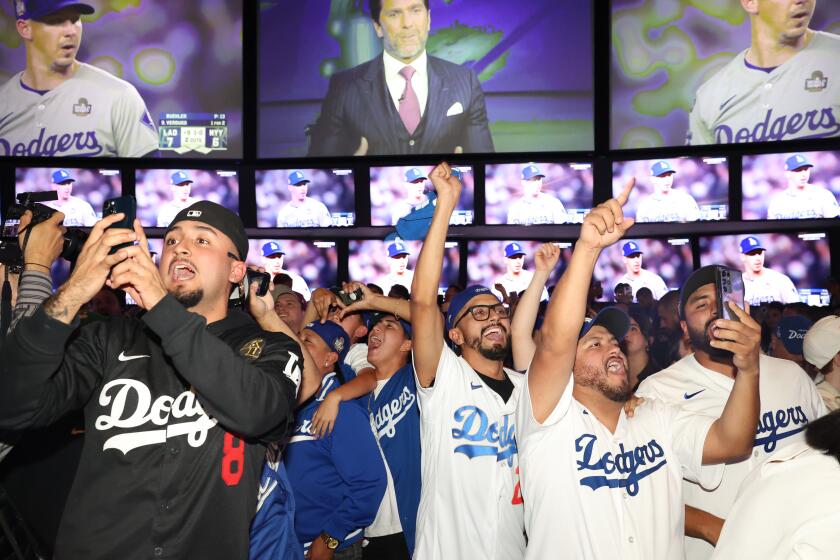 Los Angeles, CA - October 30: Dodgers fans celebrate as the Los Angeles Dodgers win.