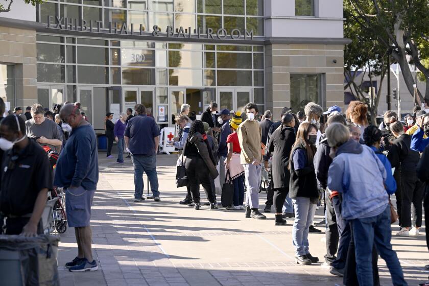 PASADENA, CA - JANUARY 12: People line up to fill out FIMA paperwork at the Pasadena Convention Center on Sunday, Jan. 12, 2025 in Pasadena, CA. (John McCoy / For The Times)