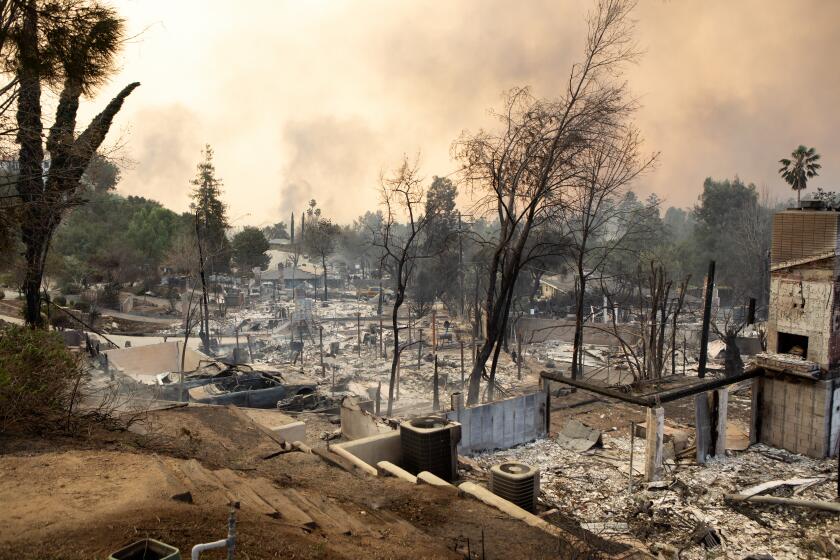 Altadena, CA. January 8, 2025 - Street view of burned homes devastated by the Eaton Fire on Wednesday, Jan. 8, 2025 located at the corner of Rubio Canyon and E Alta Loma Drive in Altadena, Ca. Including the home of musician/sound engineer Jake Viator. (G L Askew II)