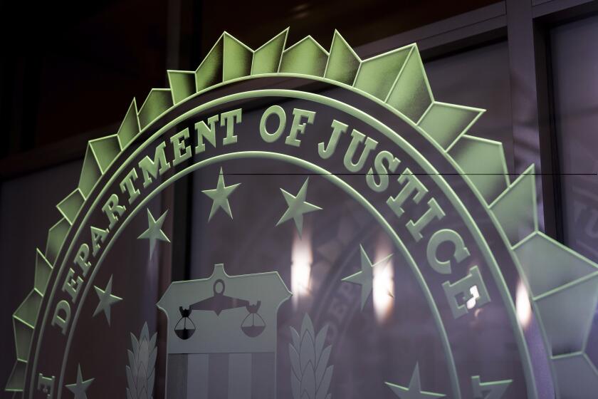 The words Department of Justice are displayed at the FBI field office in Portland, Ore., Thursday, Jan. 16, 2025. (AP Photo/Jenny Kane)