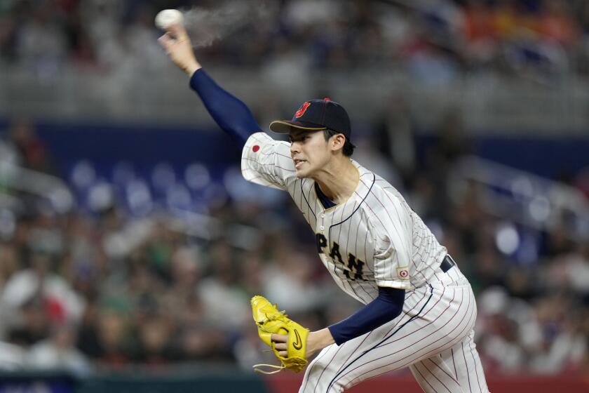 FILE- Japan's Roki Sasaki delivers a pitch during the first inning of a World Baseball Classic game against Mexico, Monday, March 20, 2023, in Miami. (AP Photo/Wilfredo Lee, File)