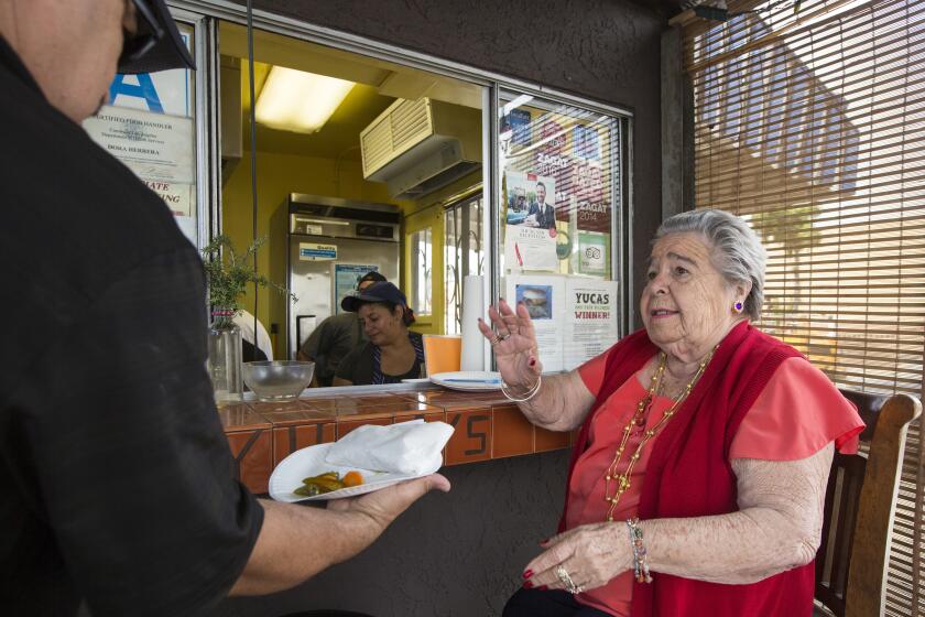 LOS FELIZ, CALIF. -- TUESDAY, APRIL 26, 2016: Soccoro Herrera takes orders from her chair by the window at Yuca's Tacos