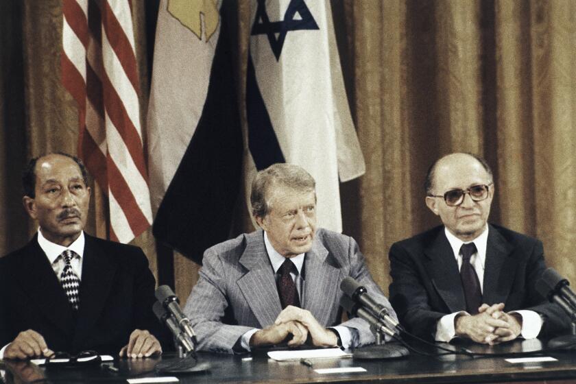 FILE - President Jimmy Carter, center, is flanked by Israeli Prime Minister Menachem Begin and Egypt's President Anwar Sadat as they faced newsmen at the conclusion of their discussions toward Middle East Peace moves at Carter's Camp David retreat in Maryland in September 1978. (AP Photo, File)