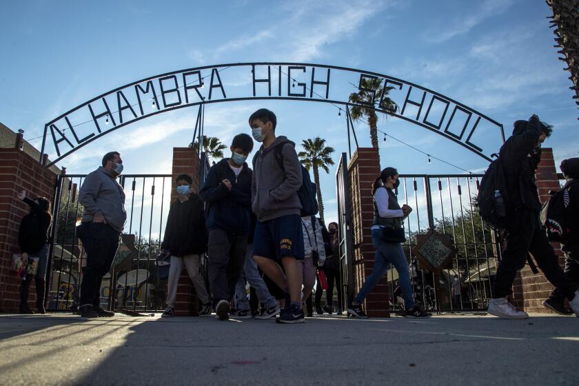 ALHAMBRA, CA - January 03 2022: Alhambra High School students head off for the day after the final bell rang on Monday, Jan. 3, 2022 in Alhambra, CA. (Brian van der Brug / Los Angeles Times