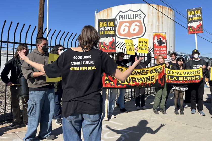 CARSON, CALIF. JANUARY 16, 2025 - Sunrise Movement LA held a demonstration calling out the role "Big Oil" at the Phillips 66 Gas Storage Facility in Carson on Thursday, January 16, 2025. (Myung J. Chun / Los Angeles Times)