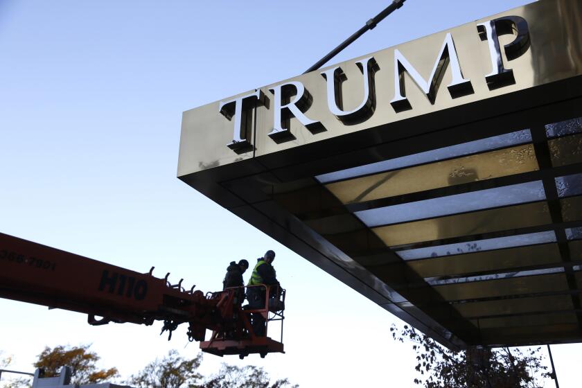 Workmen remove the letters from a building formerly known as Trump Place in New York, Wednesday, Nov. 16, 2016. Donald Trump's name is being stripped off three luxury apartment buildings after hundreds of tenants signed a petition saying they were embarrassed to live in a place associated with the Republican President-elect. (AP Photo/Seth Wenig)