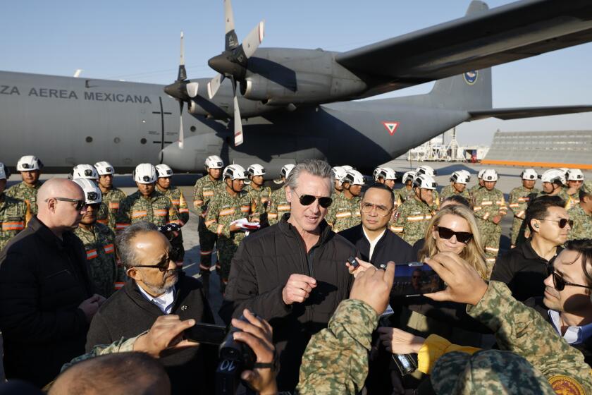 Los Angeles, CA - January 11: California Gov. Gavin Newsom greets firefighters from Mexico arriving to combat multiple wildfires overtaking southern California at LAX on Saturday, Jan. 11, 2025 in Los Angeles, CA. (Carlin Stiehl / For the Times)