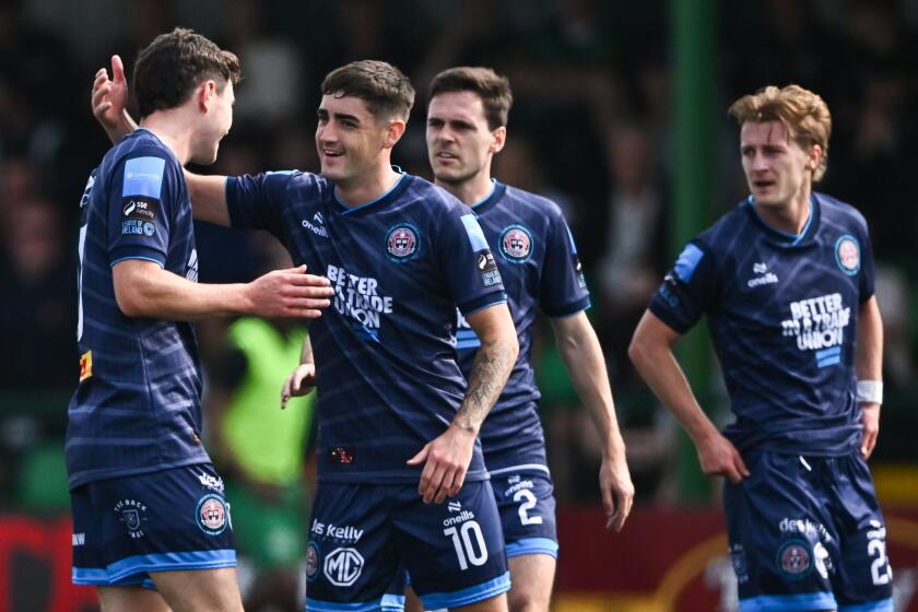 Kerry , Ireland - 18 August 2024; James Clarke of Bohemians celebrates with team-mate Dawson Deveoy.