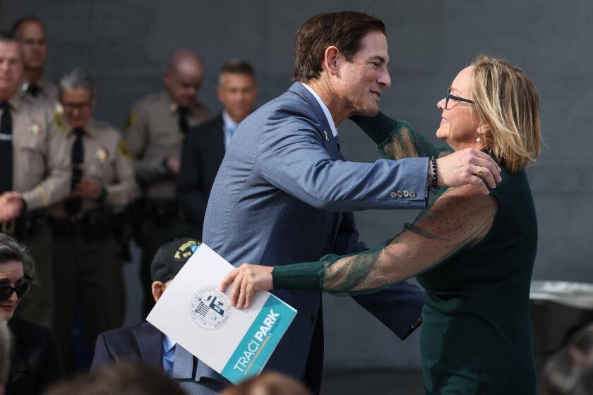 Los Angeles, CA, Tuesday, December 3, 2024 - Nathan Hochman embraces LA City Councilwoman Traci Park after she spoke at his swearing in ceremony as Los Angeles District Attorney at the Hall of Justice, downtown. Robert Gauthier/Los Angeles Times)