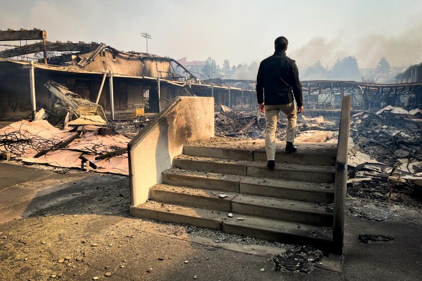 L.A. schools Supt. Alberto Carvalho inspects fire damage at in Pacific Palisades.