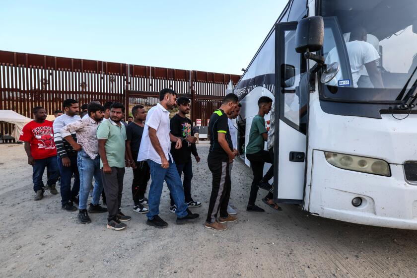 San Diego, CA, Wednesday, June 5, 2024 - People seeking asylum are detained by border patrol after crossing the US/Mexico border. (Robert Gauthier/Los Angeles Times)