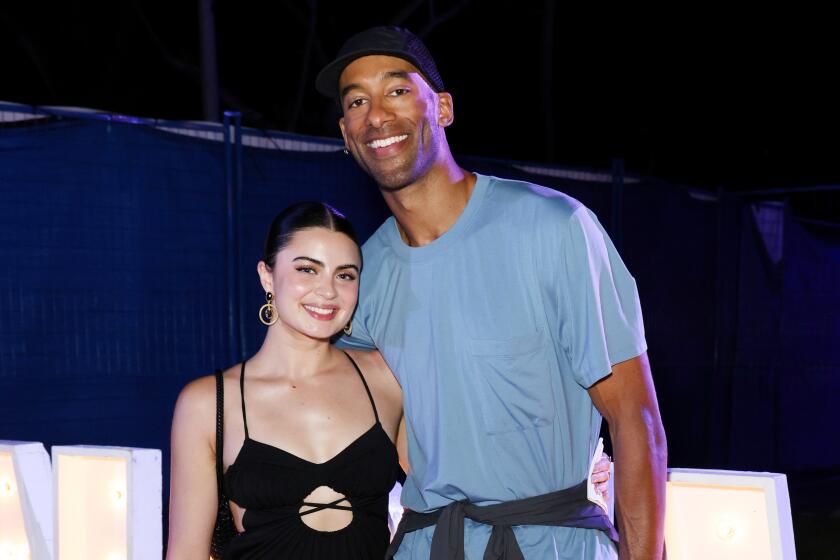 Rachael Kirkconnell and Matt James pose for photographers together in the Bahamas