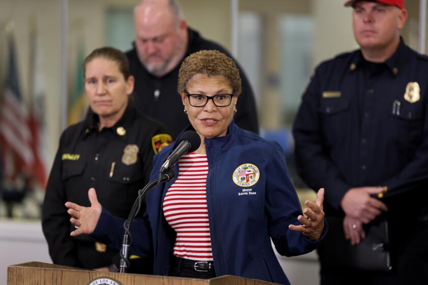 Los Angeles, California-Jan. 11, 2025-Los Angeles Mayor Karen Bass, center, and Los Angeles Fire Chief Kristin Crowley, left, address the media at a press conference on Saturday, Jan. 11, 2025. (Allen J. Schaben/Los Angeles Times)