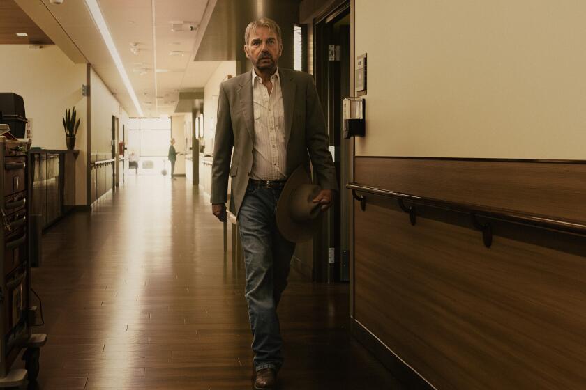 A man walks down a hospital corridor.