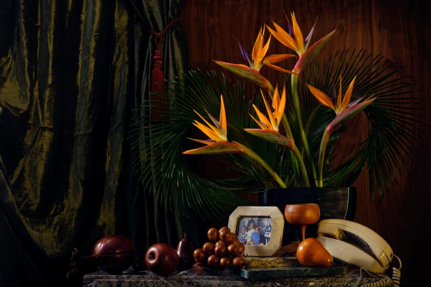 Bird of paradise arrangement in living room scene with writer Jason Parham's family photo.