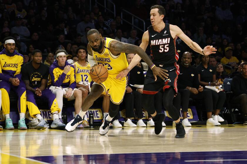 Los Angeles Lakers forward LeBron James drives to the basket against Miami Heat forward Duncan Robinson during the first half of an NBA basketball game, Wednesday, Jan. 15, 2025, in Los Angeles. (AP Photo/Kevork Djansezian)