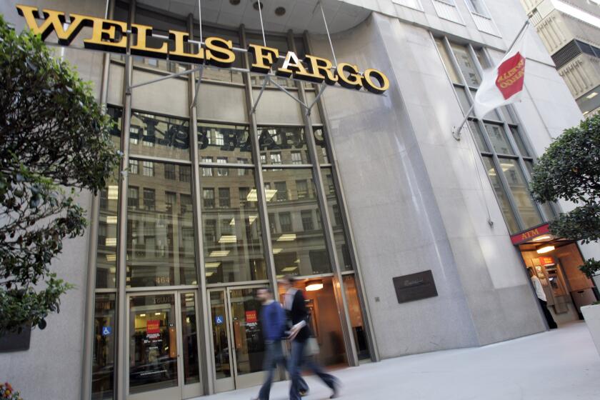 ** FILE ** In this Oct. 15, 2008 file photo, of a Wells Fargo Bank in San Francisco. Talk about throwing in the kitchen sink. Wells Fargo & Co. said Wednesday, Jan. 28, 2009, that it swung to a $2.83 billion loss in the fourth quarter as it took significant charges to reduce its exposure to the risky assets of Wachovia Corp. and built up its reserves to cover future losses. (AP Photo/Paul Sakuma, file)