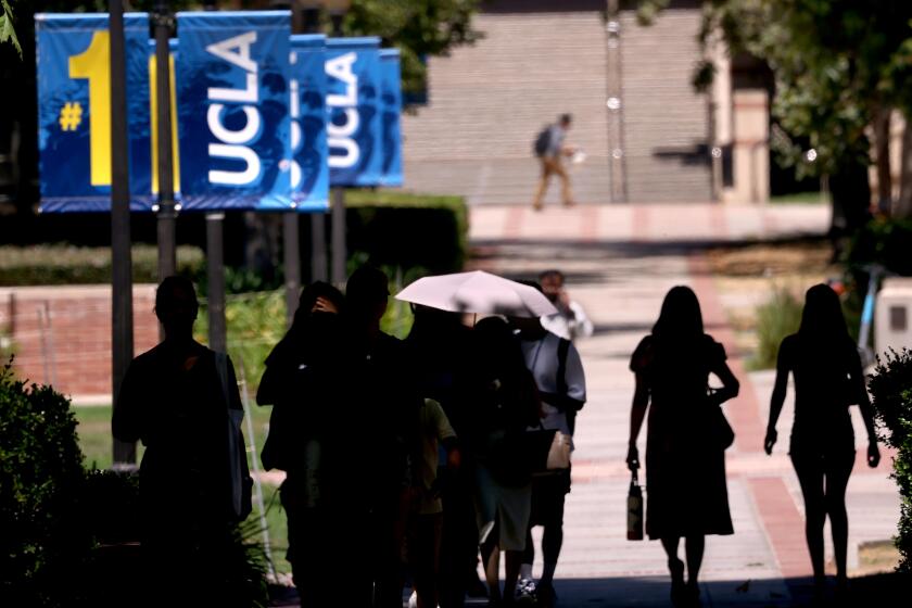 WESTWOOD, CA - AUGUST 15, 2024 - Students and visitors make their way on the UCLA campus in Westwood on August 15, 2024. (Genaro Molina/Los Angeles Times)