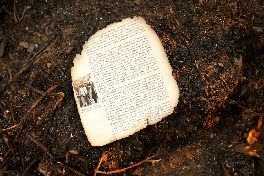 PACIFIC PALISADES, CA, JANUARY 11, 2025: A page from a book sits at a home that burned in the Pacific Palisades Fire on Saturday, January 11, 2025. (Christina House / Los Angeles Times)