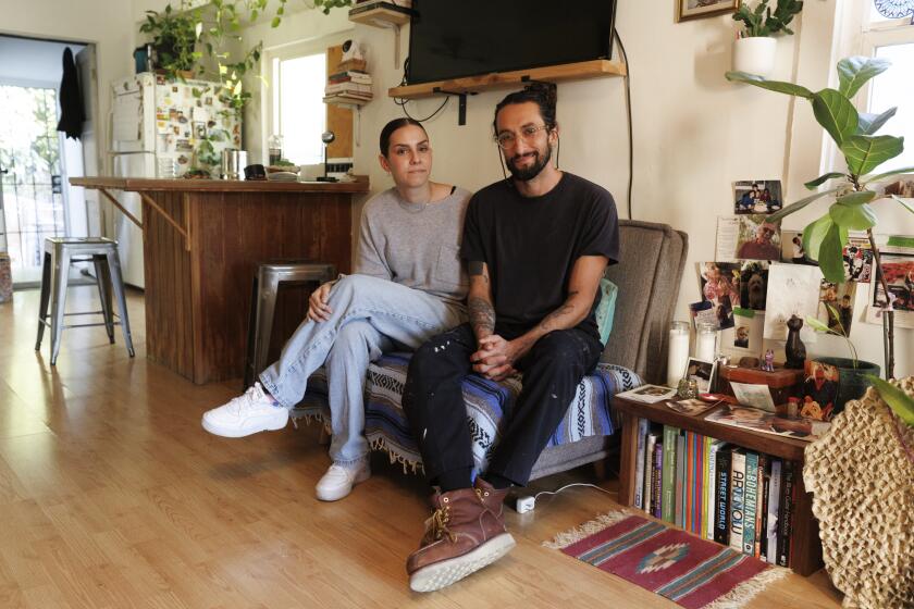 Los Angeles, CA - November 07: Claire Bernson and Andres Cortes sit inside his Cypress Park property on Thursday, Nov. 7, 2024 in Los Angeles, CA. (Carlin Stiehl / For the Times)