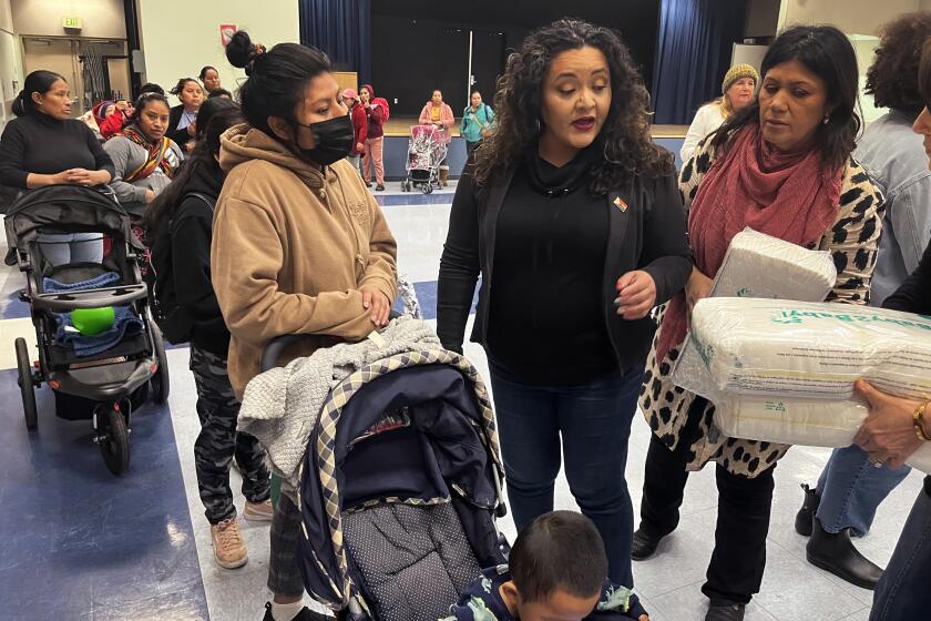 Los Angeles, California-Jan. 9, 2025-School board member Rocio Rivas, center, helps with the distribution of diapers at Liechty Middle School, on the west edge of downtown, on Friday, Jan. 10. The donated diapers were handed out along with wipes and meal bags for students to help families cope with the ongoing closure of campuses and other hardships related to the wind-fueled fires that have swept across large swaths of Los Angeles County. (Howard Blume/Los Angeles Times)