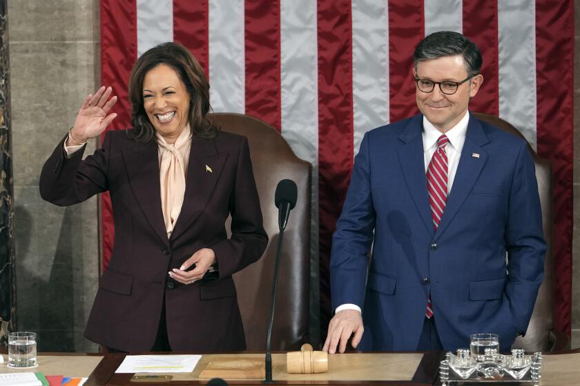 Vice President Kamala Harris stands with House Speaker Mike Johnson of La., as a joint session of Congress convenes to confirm the Electoral College votes, affirming President-elect Donald Trump's victory in the presidential election, Monday, Jan. 6, 2025, at the U.S. Capitol in Washington. (AP Photo/Matt Rourke)