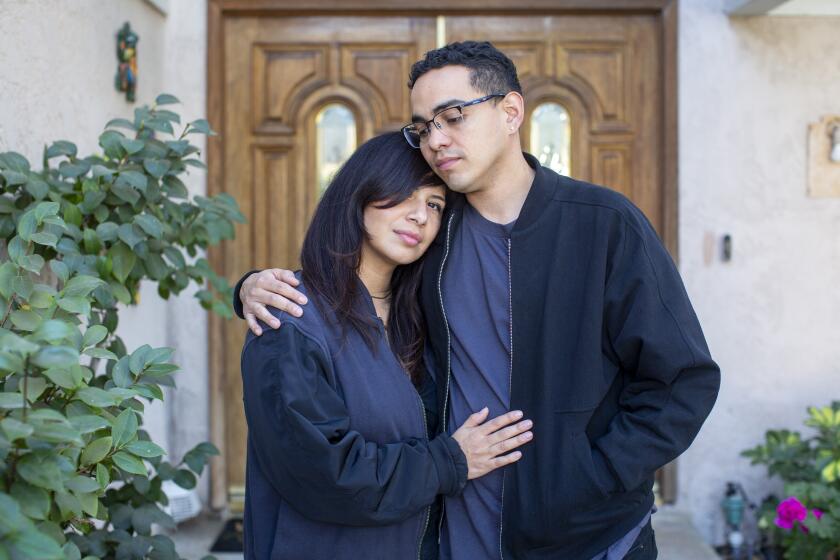 Hacienda Heights, CA - January 16: Danielle Stone, left, and her husband, are photographed at their friend's house on Thursday, Jan. 16, 2025, in Hacienda Heights, CA. Danielle Stone and Bryan Davila lost their home in the Eaton fire. They evacuated to her parents home on the night of the fire. But then the fire made its way to their home. The fire also destroyed Danielle's 90-year-old grandmother's home. Danielle is a 4th generation Altadena resident. She and her husband purchased their home in 2022 and have a 1 year old daughter, Melina.(Ringo Chiu / For The Los Angeles Times)