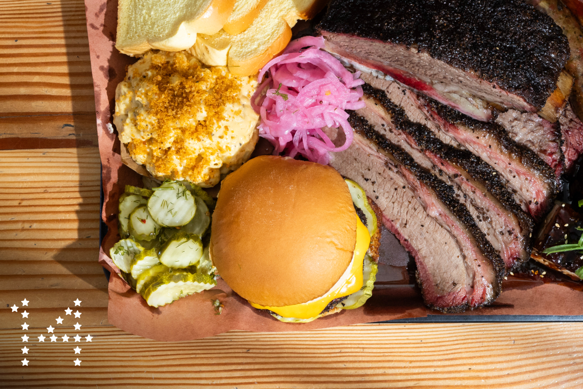 LOS ANGELES, CA - OCTOBER 11: BBQ platter with beef ribs, top center, brisket, sausage, pork belly, bottom right, Thicc burger and mac and cheese at Moo's Craft Barbecue in Los Angeles, CA on Friday, Oct. 11, 2024. (Myung J. Chun / Los Angeles Times)