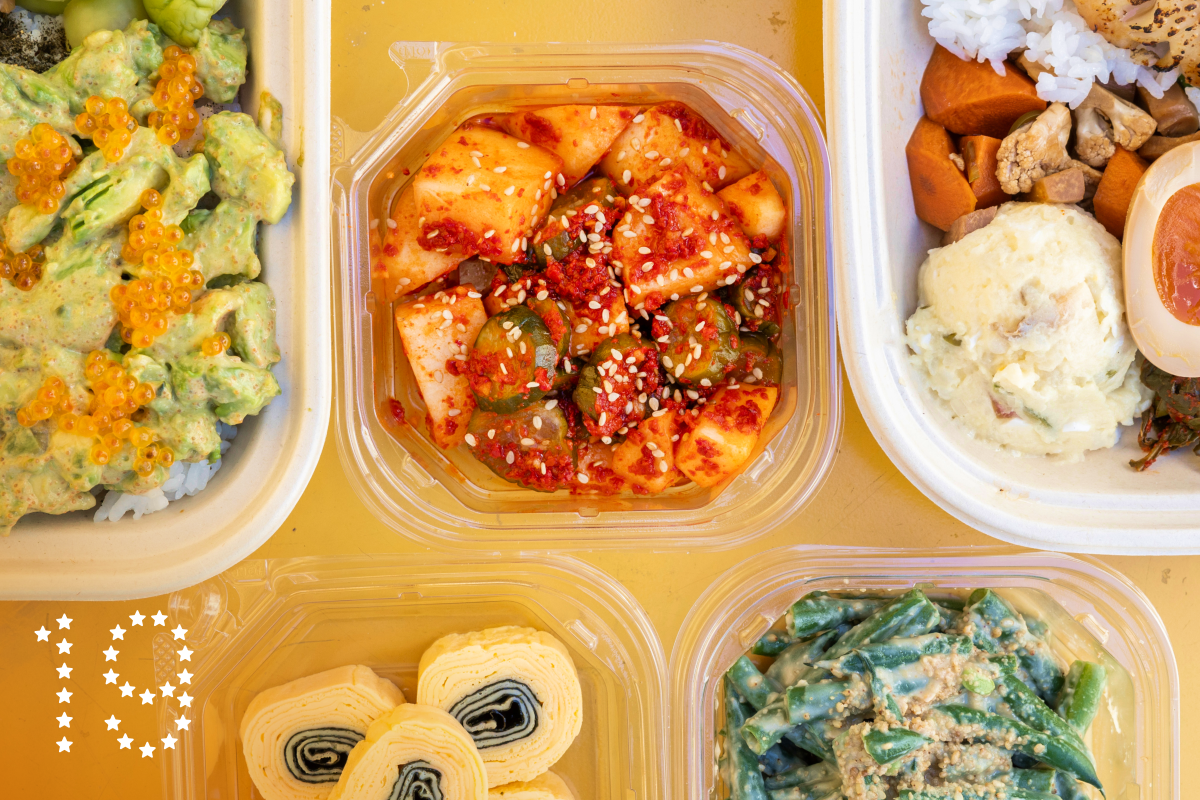 LOS ANGELES, CA - SEPTEMBER 05: Avocado and mentaiko rice, left; cod dosirak, right, and various banchan - rolled egg, bottom left, fermented cucumber and melon and sesame green beans at Perilla LA in Los Angeles, CA on Thursday, Sept. 5, 2024. (Myung J. Chun / Los Angeles Times)