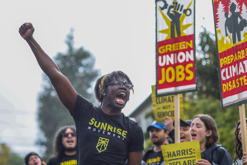 Brentwood, CA, Sunday, April 14, 2024 - Josiah Edwards leads a group Sunrise Movement protesters near VP Harris' Brentwood home calling on her to urge President Biden to declare a climate emergency. (Robert Gauthier/Los Angeles Times)