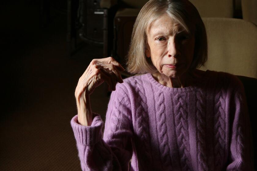 A woman posing in a cable-knit purple sweater