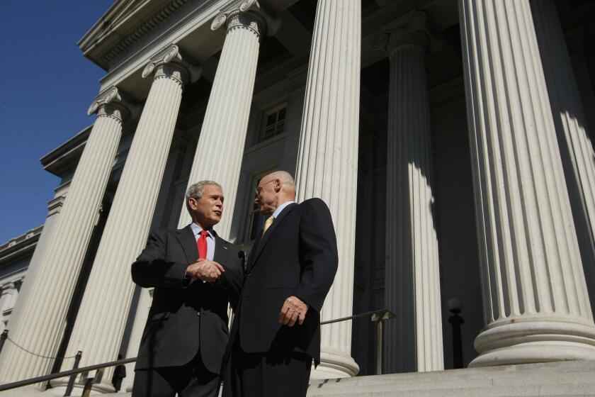 President Bush shakes hands with Treasury Secretary Henry Paulson at the Treasury Department in Washington after the House passed the $700 billion financial bailout bill, Friday, Oct. 3, 2008. (AP Photo/Charles Dharapak)