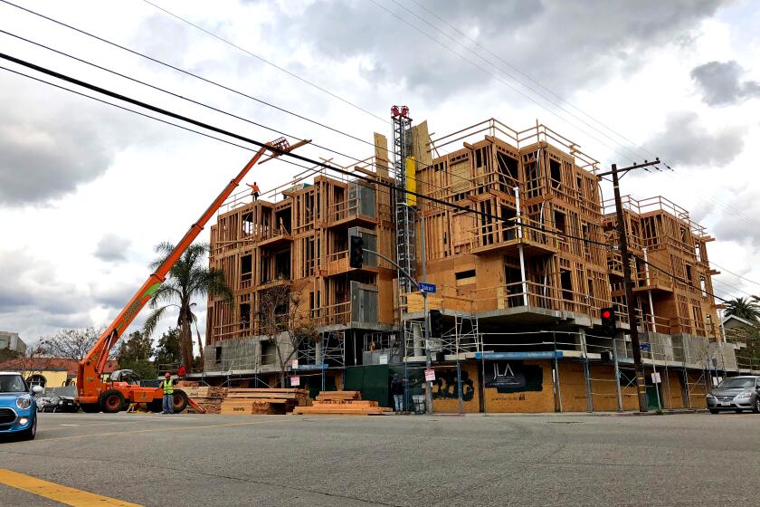 Construction workers on Friday, March 20, 2020, were busy building a new apartment building in the Palms neighborhood of Los Angeles. (Andrew Khouri / Los Angeles Times)