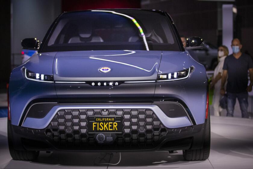 Los Angeles, CA - November 19: Car enthusiasts view the new Fisker Ocean all electric vehicle at the LA Auto Show opening day at Los Angeles Convention Center in Los Angeles, CA on Friday, Nov. 19, 2021. The Ocean features a full-length SolarSky roof, that can harvest the sun's rays to generate free energy to support the vehicle's battery-powered motor. (Allen J. Schaben / Los Angeles Times)