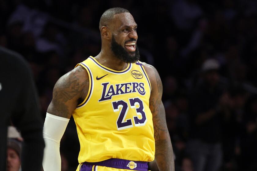 Los Angeles Lakers forward LeBron James celebrates with Anthony Davis after a scoring basket against Miami Heat