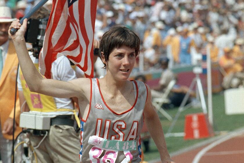 FILE - In this Aug. 5, 1984, file photo, U.S. runner Joan Benoit waves the American flag.