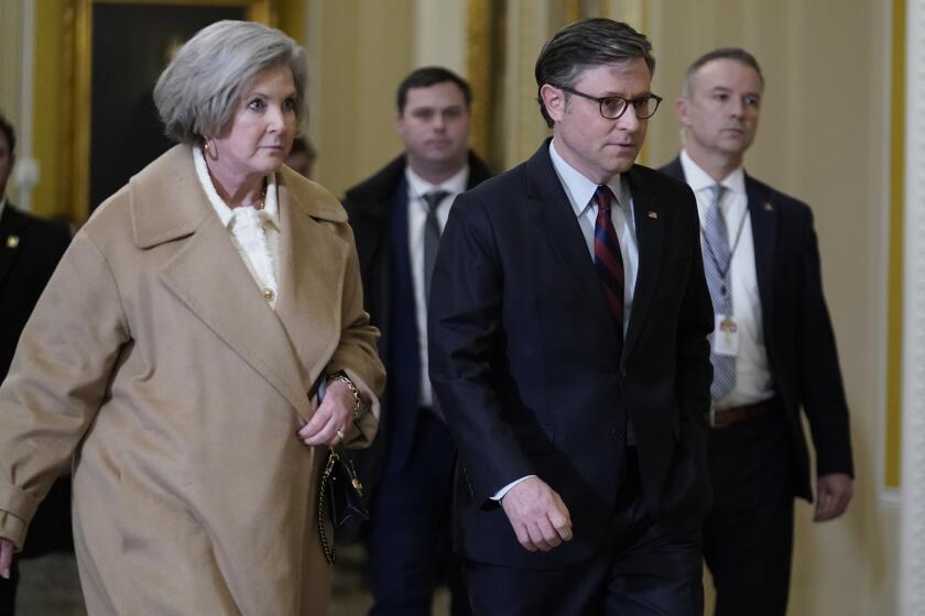 House Speaker Mike Johnson of La., walks with Susie Wiles at the Capitol Wednesday, Jan. 8, 2025, in Washington. (AP Photo/Jose Luis Magana)