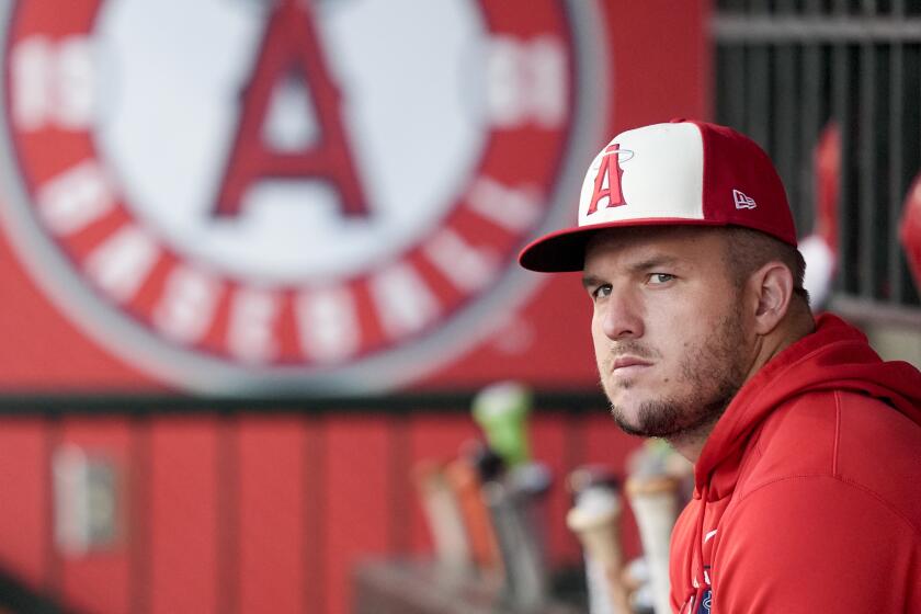 Los Angeles Angels center fielder Mike Trout sits in the dugout during the first inning of a baseball game against the New York Mets, Friday, Aug. 2, 2024, in Anaheim, Calif. (AP Photo/Ryan Sun)