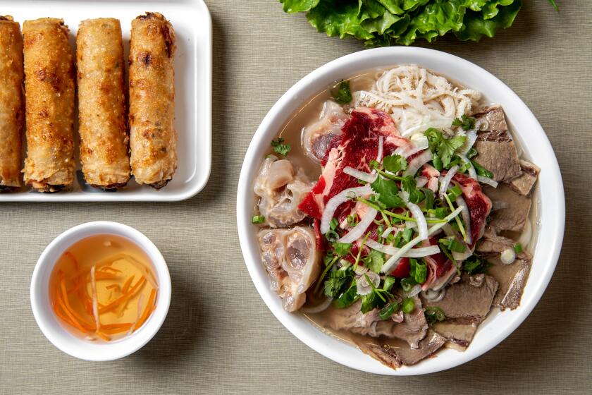 SAN GABRIEL, CA - NOVEMBER 10: Pho dac biet (Tai, Nam, Gan, Sach)-rib eye, brisket, tendon & tripe rice noodle soup and phan cha gio -fried pork egg rolls served w/vegetables from Golden Deli on Friday, Nov. 10, 2023 in San Gabriel, CA. (Mariah Tauger / Los Angeles Times)