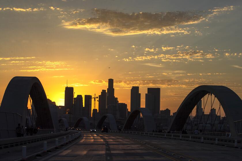 Los Angeles, CA - July 27: Clouds float over downtown Los Angeles and the new 6th Street Bridge at sunset , which has been closed intermittently since opening due to street racing and other illegal activity on Wednesday, July 27, 2022 in Los Angeles, CA. (Brian van der Brug / Los Angeles Times)