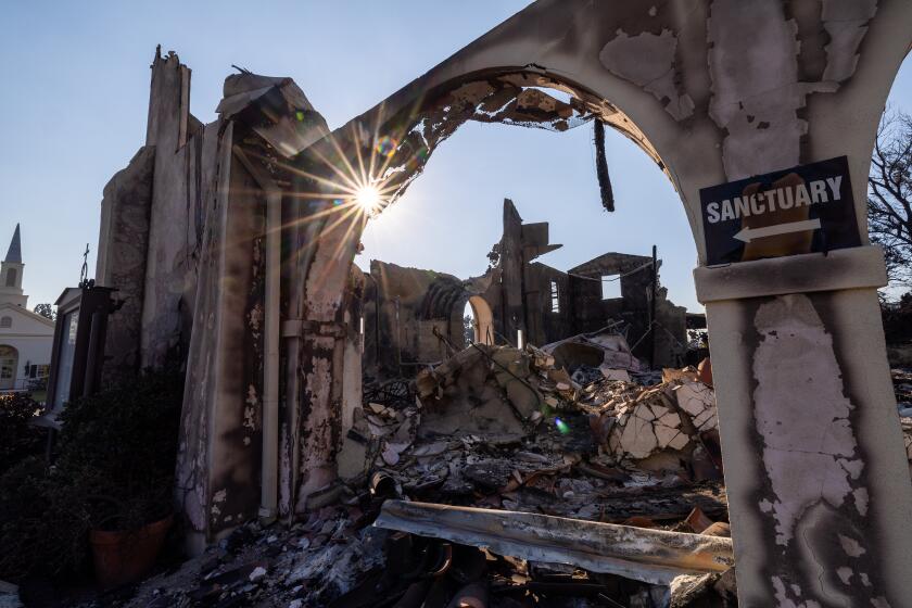 Altadena, CA - January 11: The evening sun shines through the scorched out remains of the Altadena Community Church that was burned in the Eaton fire in Altadena Saturday, Jan. 11, 2025. (Allen J. Schaben / Los Angeles Times)