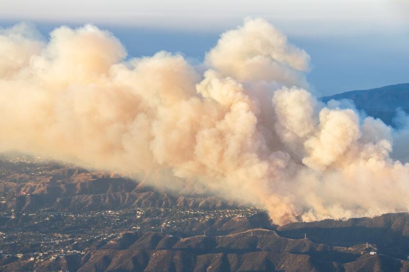 LOS ANGELES, CA - JANUARY 11: Helicopter aerial view of the Palisades fire burning in the Mountain Gate Country Club area with smoke visible from the San Fernando Valley on Saturday, Jan. 11, 2025. (Myung J. Chun / Los Angeles Times)