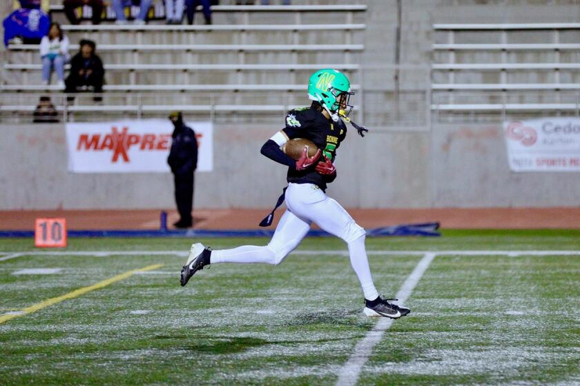 Narbonne receiver Michael Ashford scores his second in the Gauchos’ 75-31 victory over San Pedro