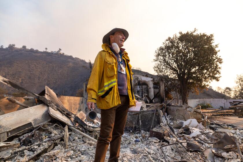 Malibu, CA - January 09: Jim Rainey surveys the remnants of his childhood home, destroyed in the Palisades fire on Thursday, Jan. 9, 2025 in Malibu, CA. (Brian van der Brug / Los Angeles Times)