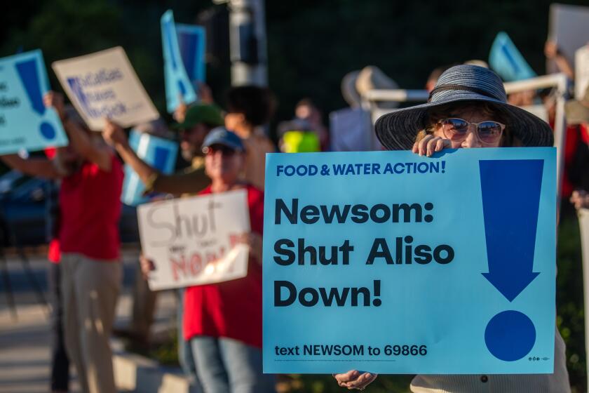 Los Angeles, CA - August 22: A group is participating in a rally at the intersection of Tampa Ave and Rinaldi on Tuesday, Aug. 22, 2023, in Los Angeles, CA. State Sen. Henry Stern and the advocacy group Food & Water Watch are hosting an evening rally calling on Gov. Gavin Newsom to follow through on his pledge to shut down the Aliso Canyon gas storage field. (Francine Orr / Los Angeles Times)