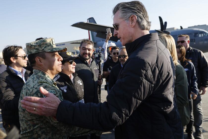 Los Angeles, CA - January 11: California Gov. Gavin Newsom greets firefighters from Mexico arriving to combat multiple wildfires overtaking southern California at LAX on Saturday, Jan. 11, 2025 in Los Angeles, CA. (Carlin Stiehl / For the Times)