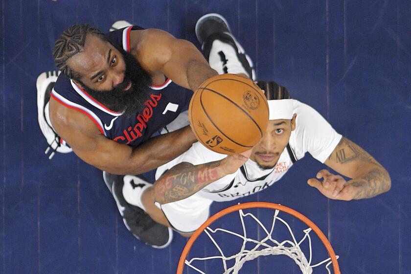 Los Angeles Clippers guard James Harden, left, and Brooklyn Nets guard Keon Johnson go after a rebound during the first half of an NBA basketball game, Wednesday, Jan. 15, 2025, in Inglewood, Calif. (AP Photo/Mark J. Terrill)